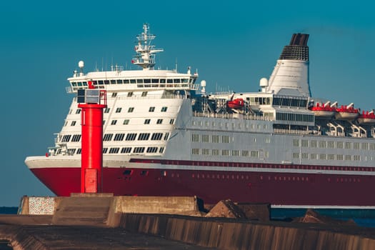 Red cruise liner. Large passenger ferry underway