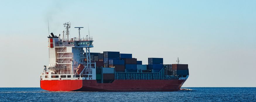 Red container ship sailing to the Baltic sea