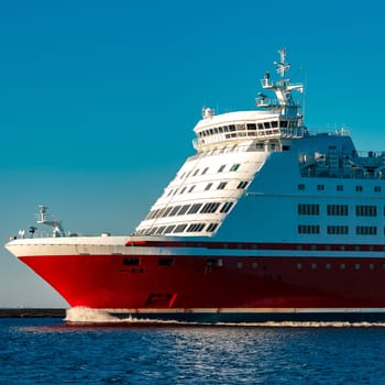 Red cruise liner. Large passenger ferry underway