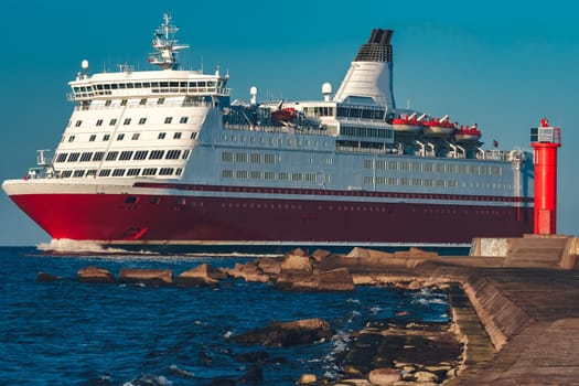 Red cruise liner. Large passenger ferry underway