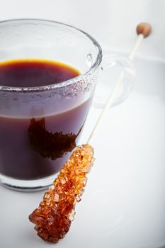 Cup of Coffee with sugar swizzle stick.  Shallow DOF