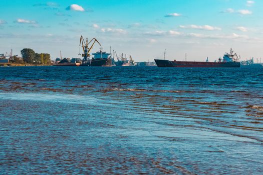 Blue cargo ship moving to the cargo port