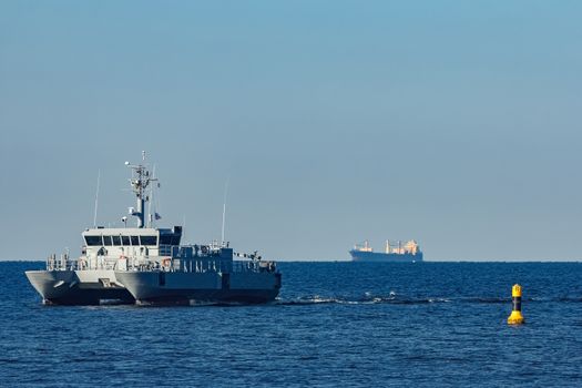 Small grey military ship moving from Baltic sea
