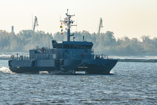 Small grey military ship moving from Baltic sea
