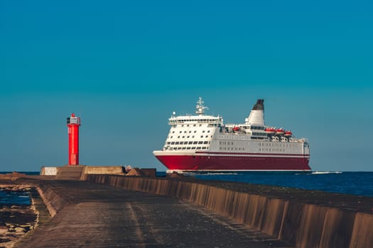 Red cruise liner. Large passenger ferry underway