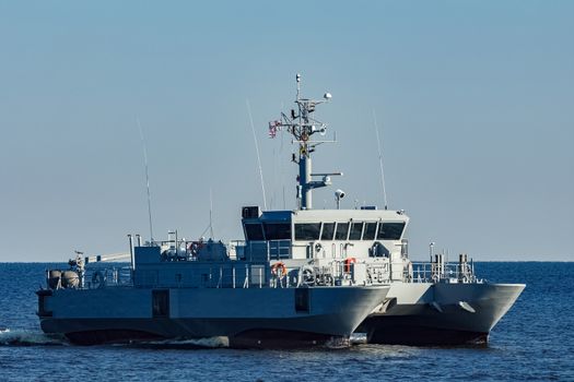 Small grey military ship moving from Baltic sea