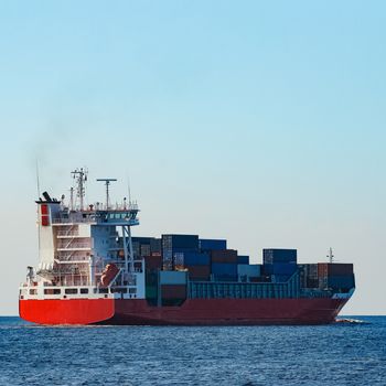 Red container ship sailing to the Baltic sea