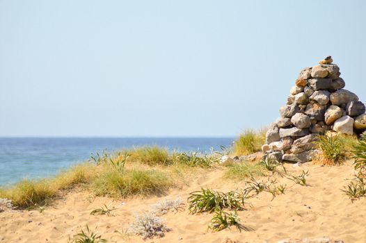 Pebble mound on a sand dune at Malia beach in Crete