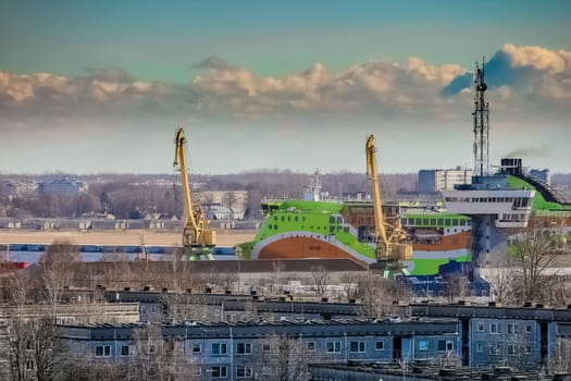 Green cruise liner. Passenger ferry sailing past the Riga city