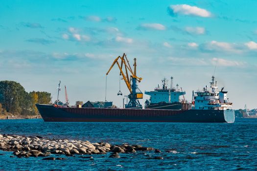 Blue cargo ship moving to the cargo port