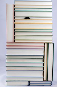 Heap of books on a white isolated background with a nib