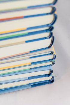 Heap of books on a white isolated background with a nib