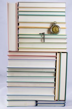 Heap of books on a white isolated background with a nib