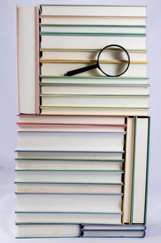 Heap of books on a white isolated background with a nib