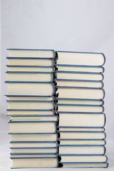 Heap of books on a white isolated background with a nib