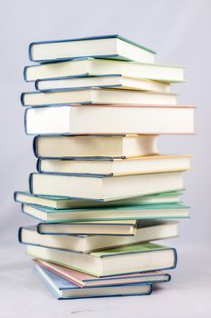 Heap of books on a white isolated background with a nib