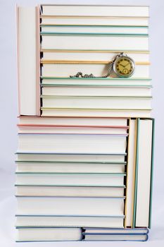 Heap of books on a white isolated background with a nib