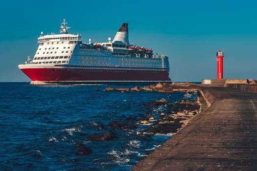 Red cruise liner. Large passenger ferry underway