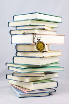 Heap of books on a white isolated background with a nib