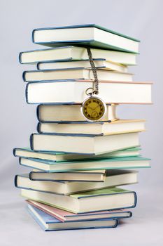 Heap of books on a white isolated background with a nib