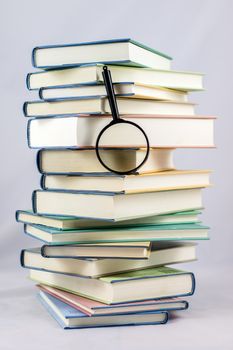 Heap of books on a white isolated background with a nib