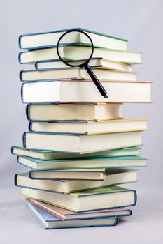 Heap of books on a white isolated background with a nib