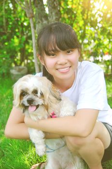 Young beautiful asian girl with the shizhu dog in the park.