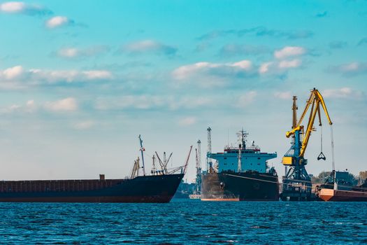 Blue cargo ship moving to the cargo port