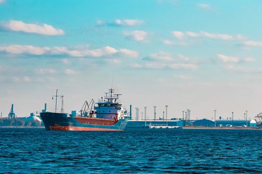 Blue cargo ship moving to the cargo port