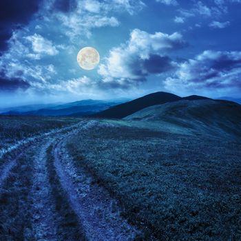 mountain landscape. path in valley  on the top of hillside at night in full moon light