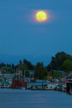 Full Moonrise over floating boat houses along Columbia River in Portland Oregon