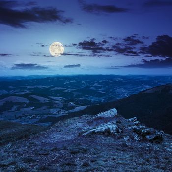 white sharp stones on the hillside at night in full moon light