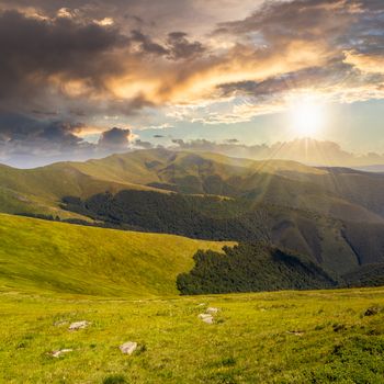 white sharp stones on the hillside of mountain range at sunset