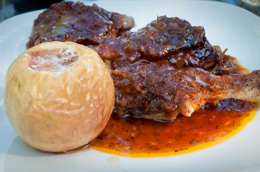 Roasted duck with apple  as served in a restaurant .