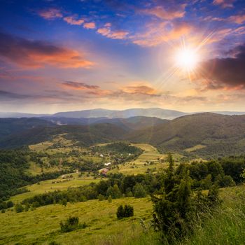 autumn landscape. village on the hillside. forest on the mountain light fall on clearing on mountains