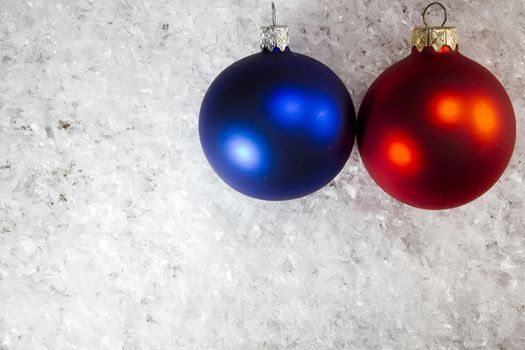 Blue and red Christmas balls on the white snow