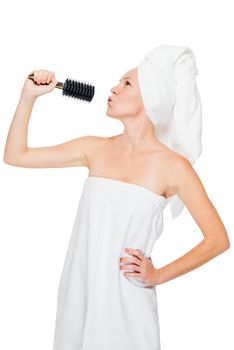 Woman with a comb for hair performs her favorite song on a white background