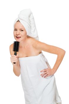 Woman with hairbrush after shower in the studio