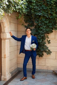 Portrait of the groom in an expensive suit