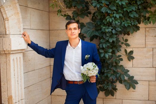 Portrait of the groom in an expensive suit