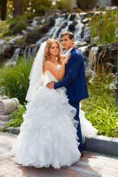 Newlyweds on a walk in the park on a warm sunny day