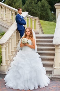 Newlyweds on a walk in the park on a warm sunny day