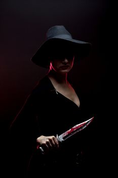 girl with a huge bloody knife in shadow, red backlight