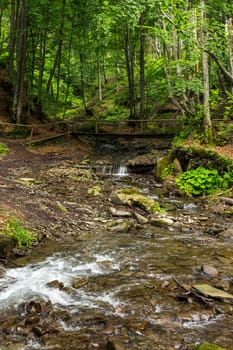 mountain river with stones and cascade in the forest 