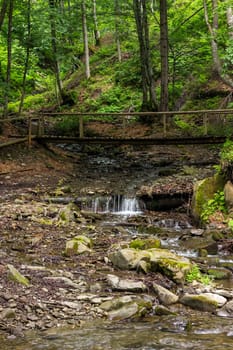 mountain river with stones and cascade in the forest 