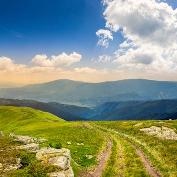 road among white sharp stones on the hillside on top of mountain range