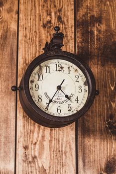 old and vintage clock on a wooden wall