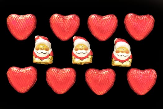 composition of red hearts and Santa Claus isolated on black background