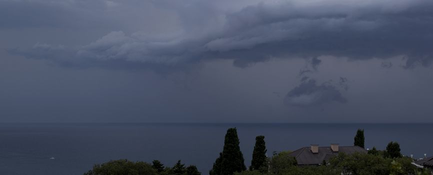 Panorama gray rain clouds over the Black Sea.