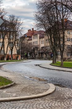 paving winds through the old town near the park in the early morning